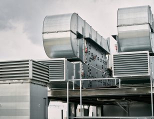 Commercial Pump HVAC. Condenser and compressor on the roof of the building. Big ventilation system. Unit of central air conditioner (AC) or heating ventilation air conditioning system